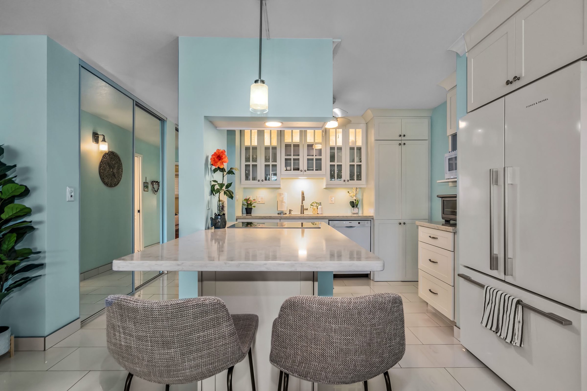 Prepare meals in your bright, modern kitchen featuring quartz countertops, stainless appliances, and an island perfect for gathering.
