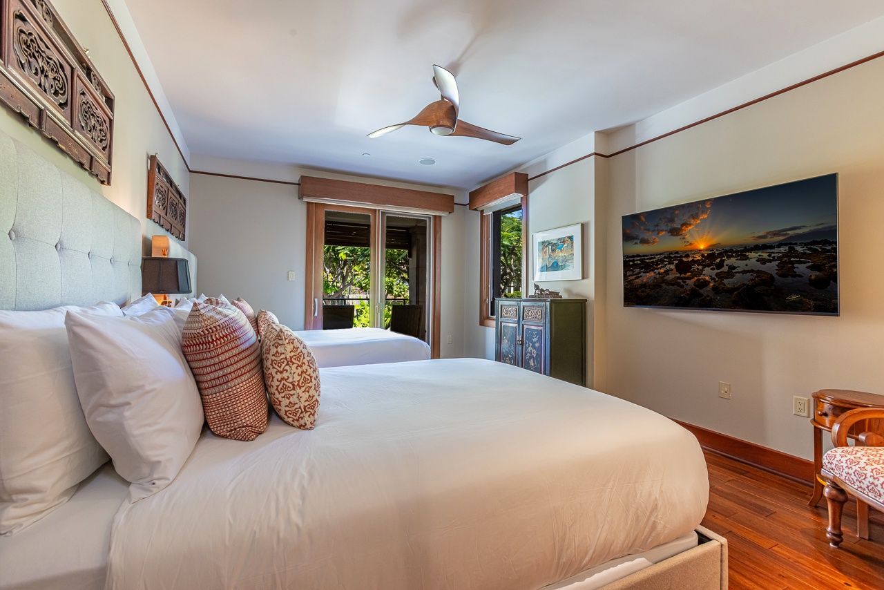 Slip into crisp linens and let the gentle ceiling fan lull you to sleep in this serene retreat, where rich wood tones and island-inspired accents create your perfect escape.