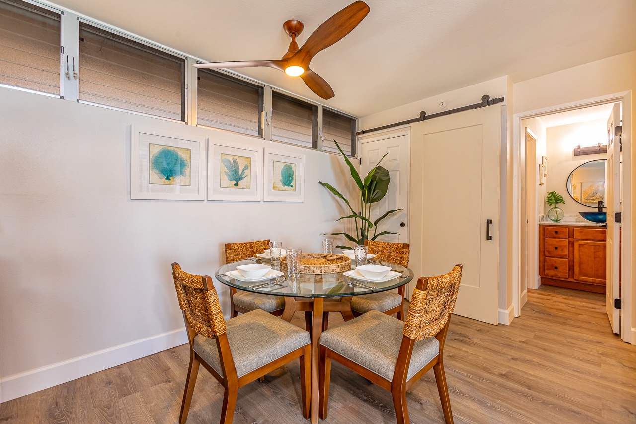 Your beautifully appointed dining space invites shared meals with loved ones, featuring coastal-inspired art, warm wood accents, and a bright ambiance perfect for memorable moments.
