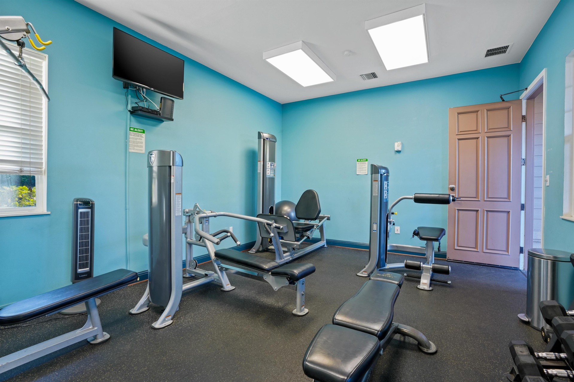 Stay energized in your bright, fully-equipped fitness center with modern machines and natural light streaming through skylights.
