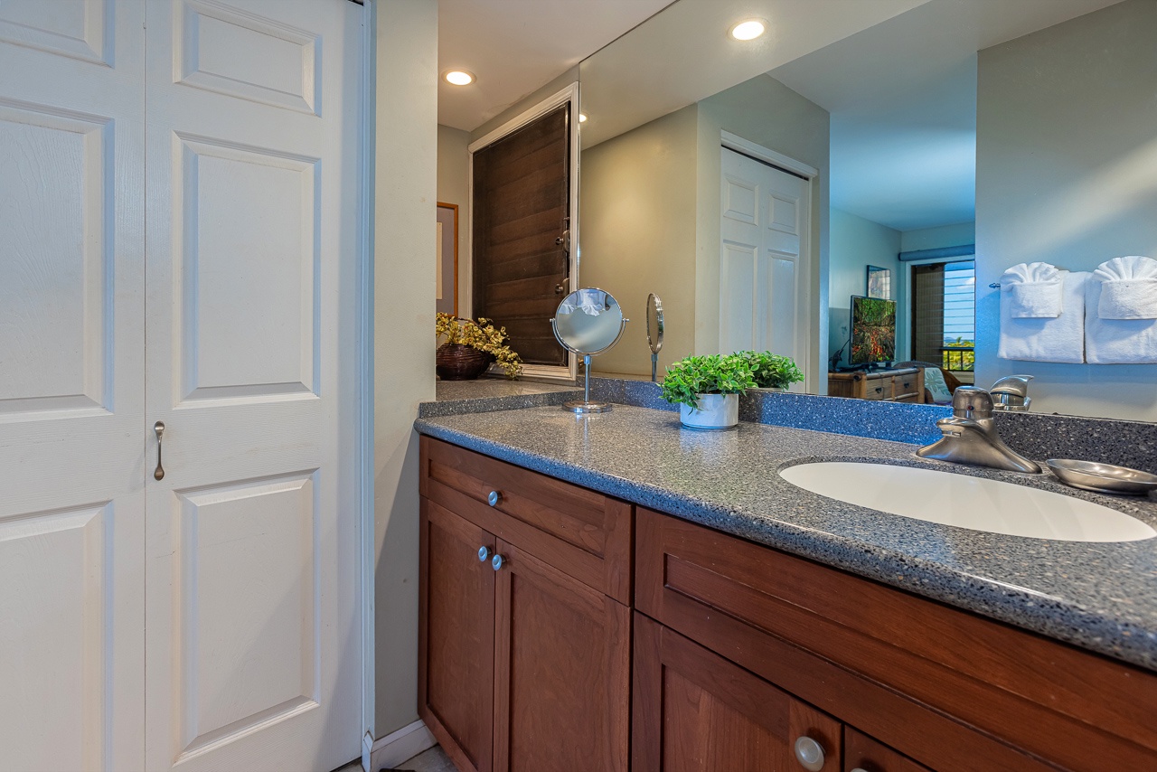 This spacious bathroom is all yours, with sleek granite counters, ample storage in warm wood cabinetry, and fresh towels waiting to make you feel instantly at home.