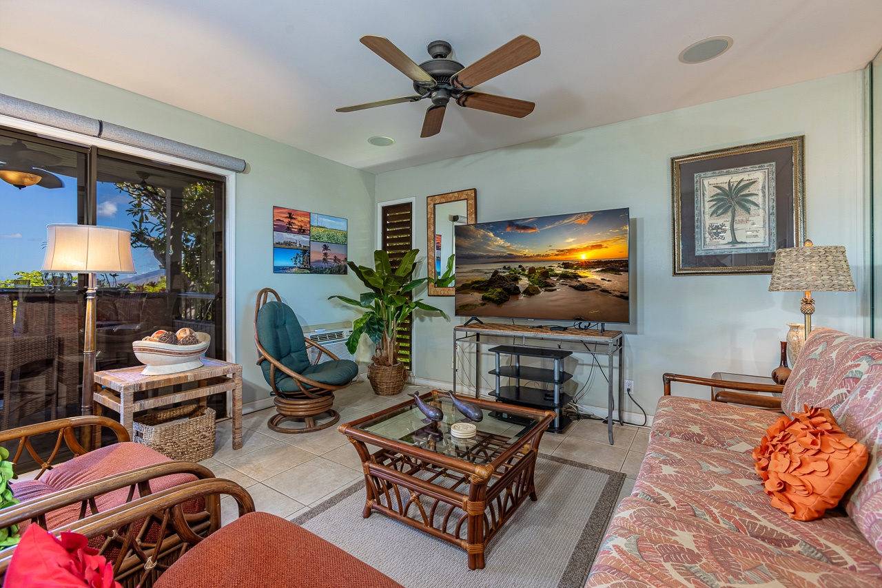 Unwind in your tropical-themed living room with island décor, sunset views on the TV, and breezy access to your private lanai—your perfect home base for relaxation.