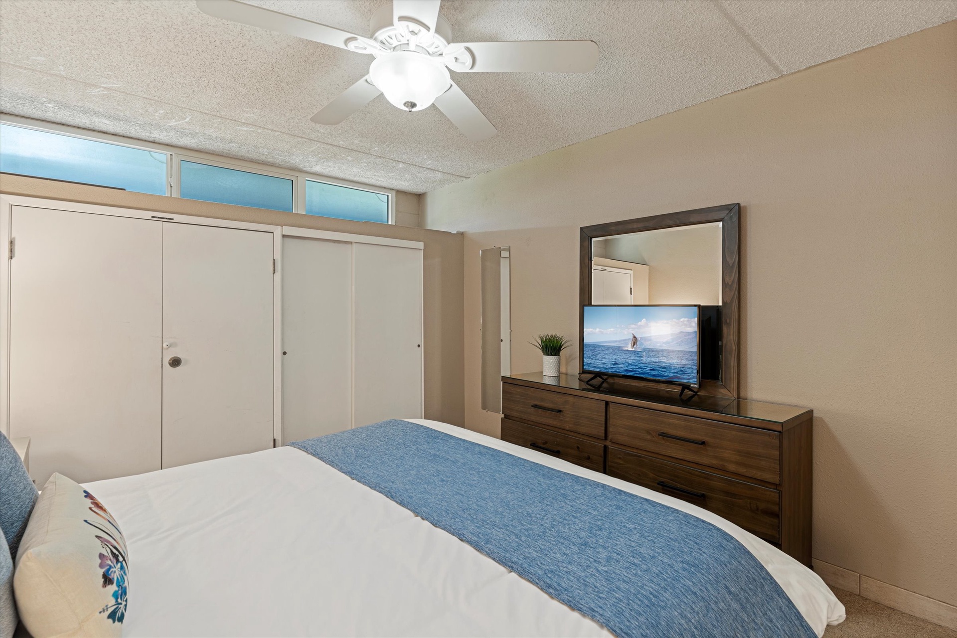 Settle into your restful bedroom with a plush bed, ocean-themed accents, and plenty of storage. The ceiling fan keeps you cool while you unwind and enjoy a favorite show.