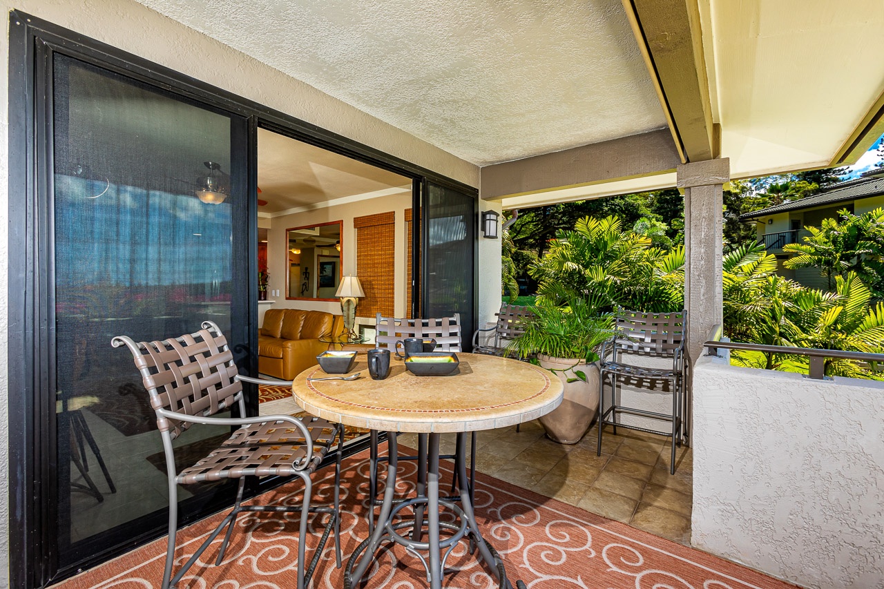 Step onto your private covered patio with tropical garden views. Relax at the outdoor table, unwind in cozy seating, and enjoy seamless indoor-outdoor living through spacious sliding doors.