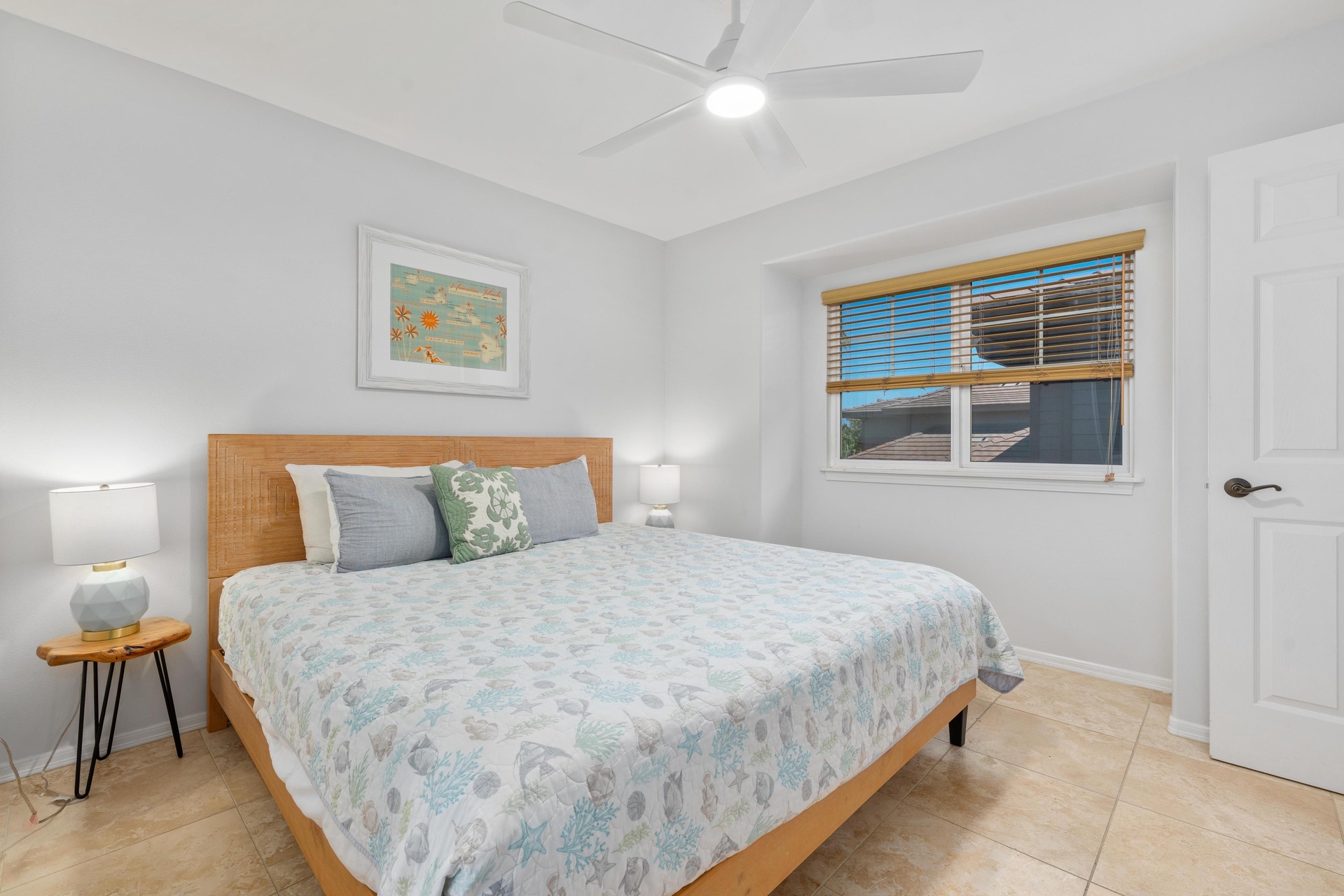 Your peaceful bedroom features coastal bedding and modern touches for restful nights.