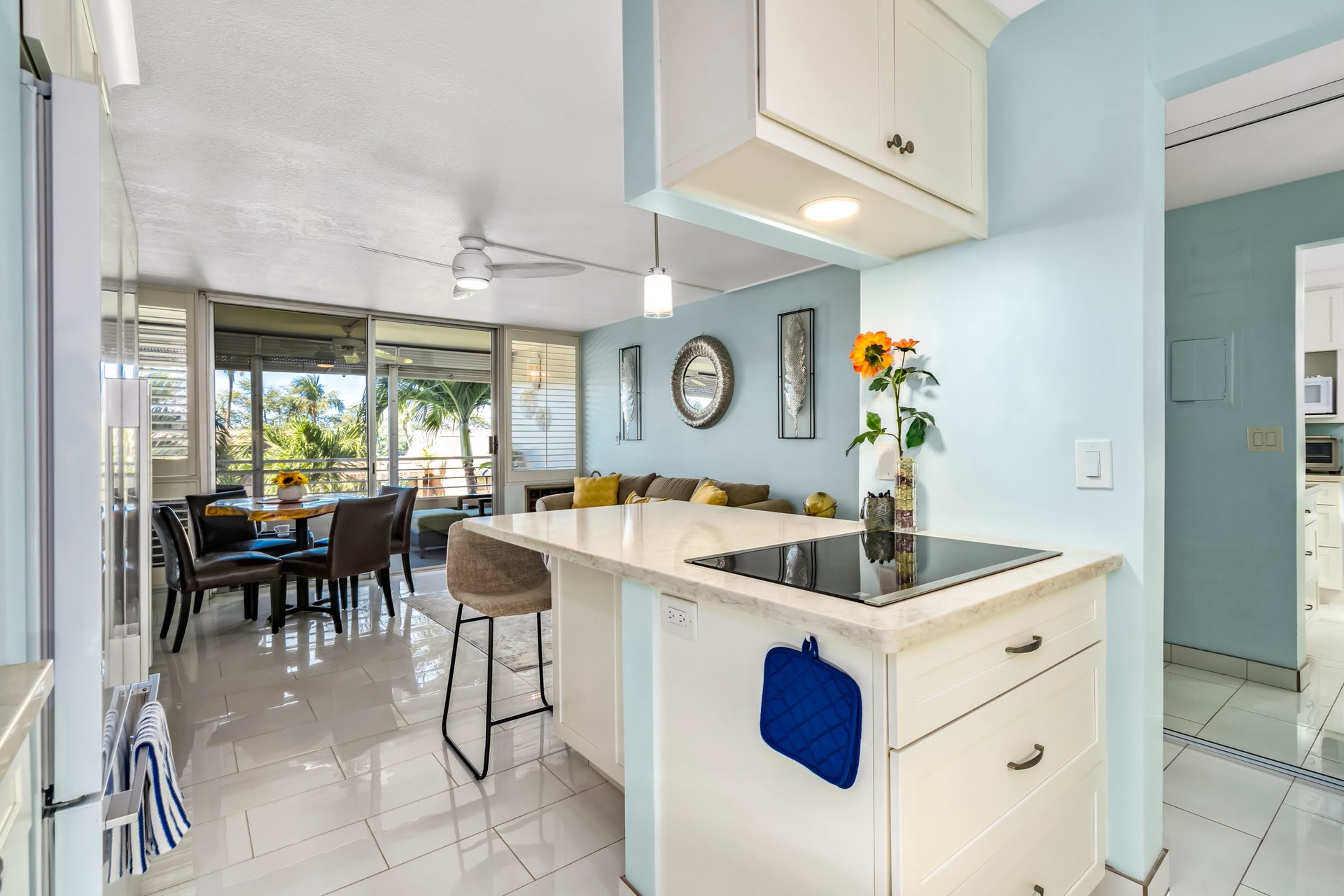 Bright, open-concept kitchen and dining area with tropical views—your home base for morning coffee and meals together.
