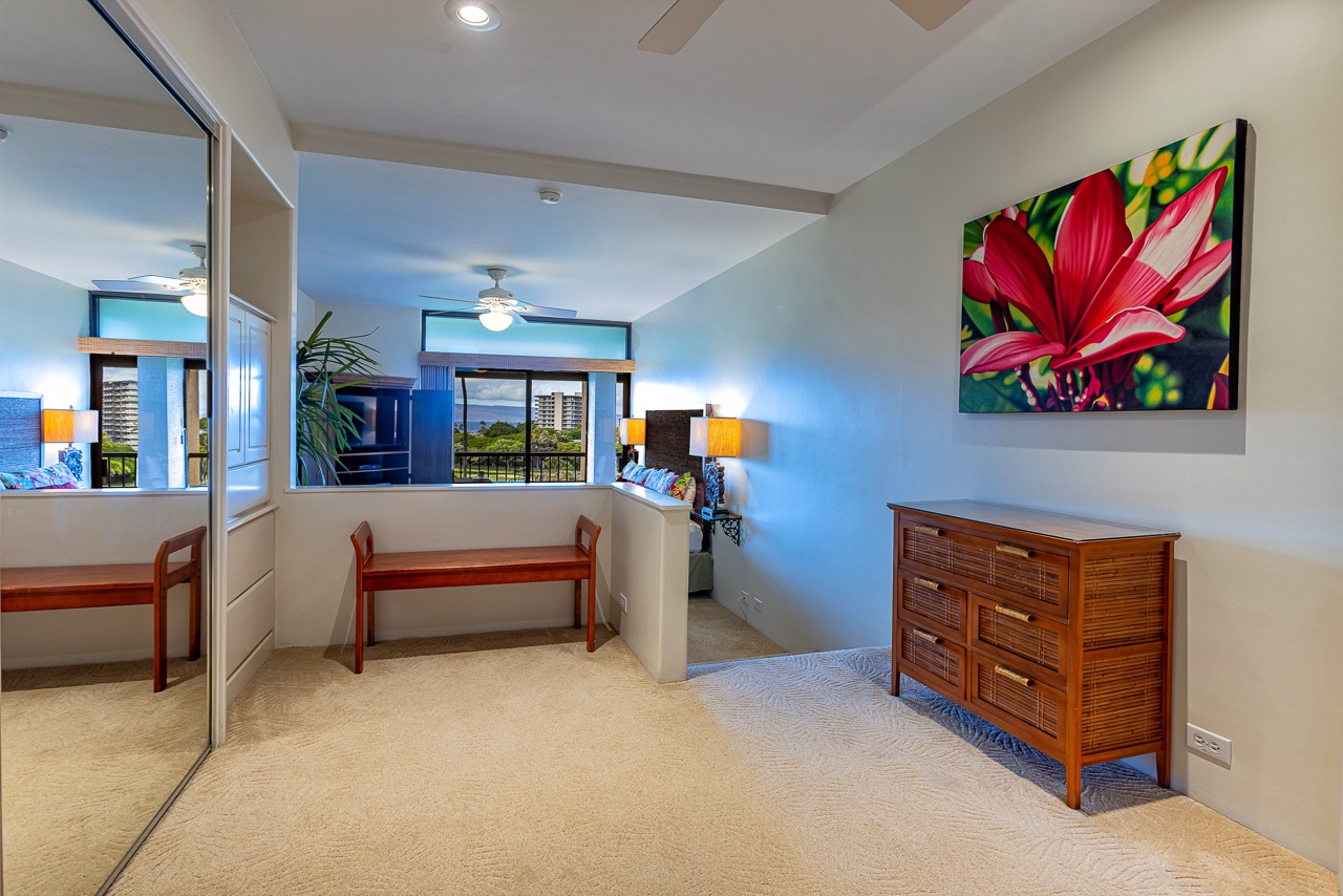 Step into your serene sleeping space, where tropical artwork and island-inspired furnishings set a relaxing tone. Soft carpet underfoot and natural light invite you to unwind after a day exploring.