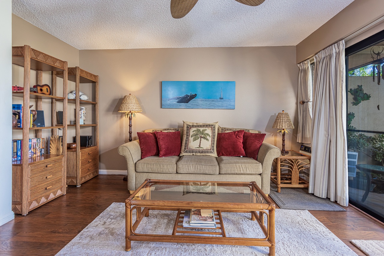 Sink into the plush sofa and unwind in this tropical-themed living room, where warm lighting create your perfect relaxation retreat.
