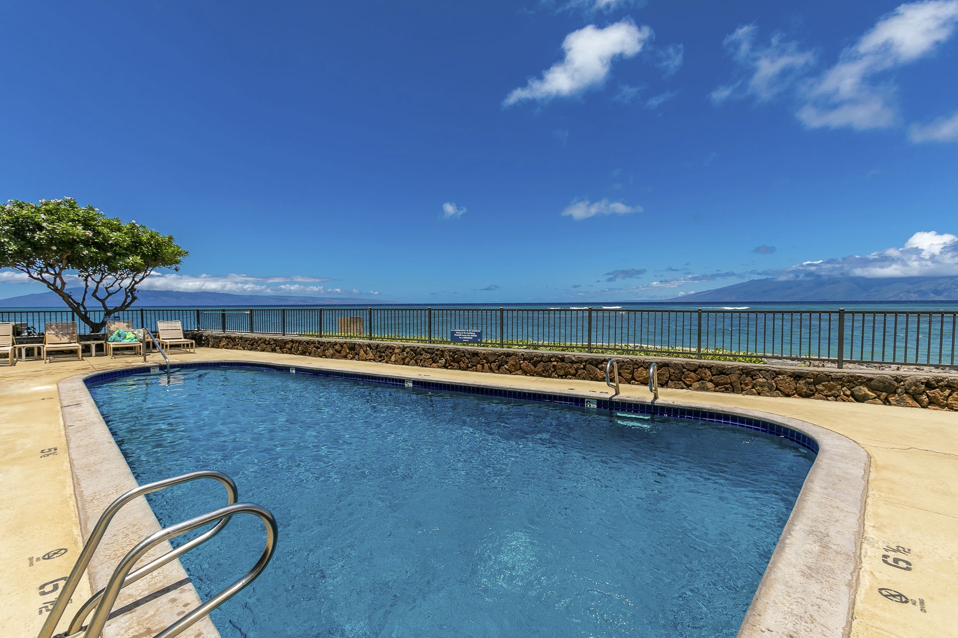 This oceanfront pool overlooks pristine turquoise waters and nearby island views.