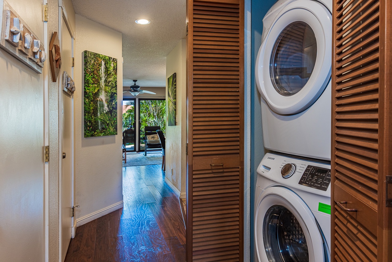 Your own in-unit washer/dryer await in this laundry nook, tucked away behind wooden louvered doors.