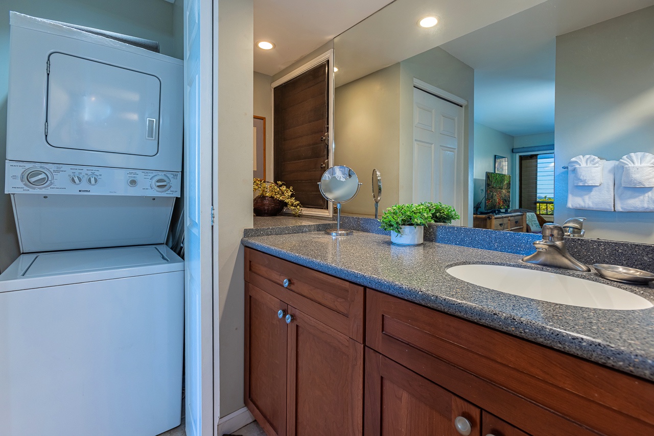 Step into your modern bathroom featuring a sleek vanity, fresh linens folded nearby, and an in-unit washer-dryer combo just steps away for your ultimate convenience.