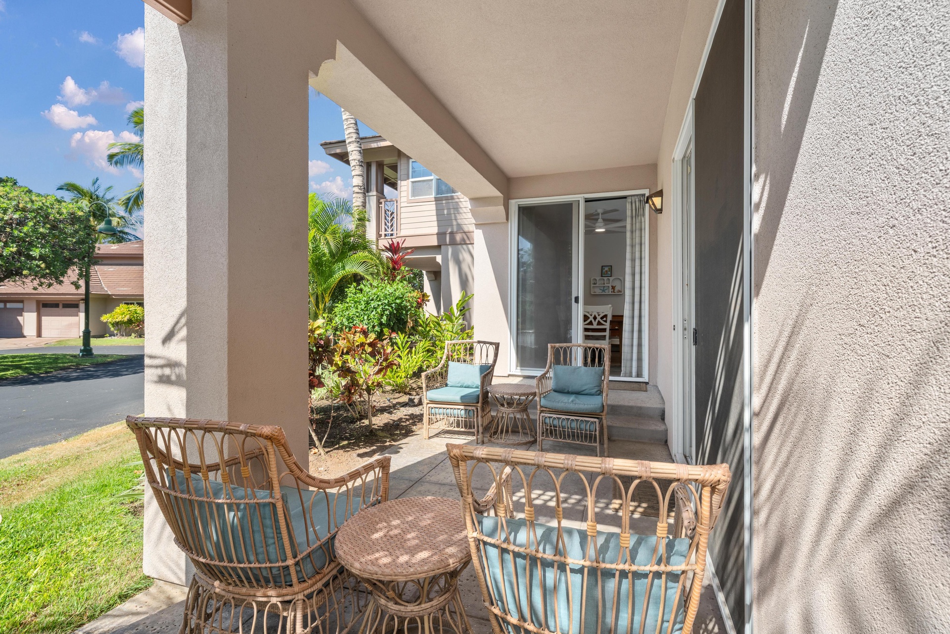 Step onto your private patio where tropical breezes and rattan seating create the perfect spot for morning coffee or evening relaxation.