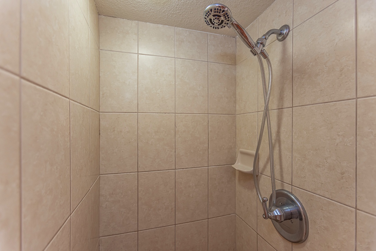 Step into a spacious walk-in shower designed for your ultimate comfort and relaxation.
