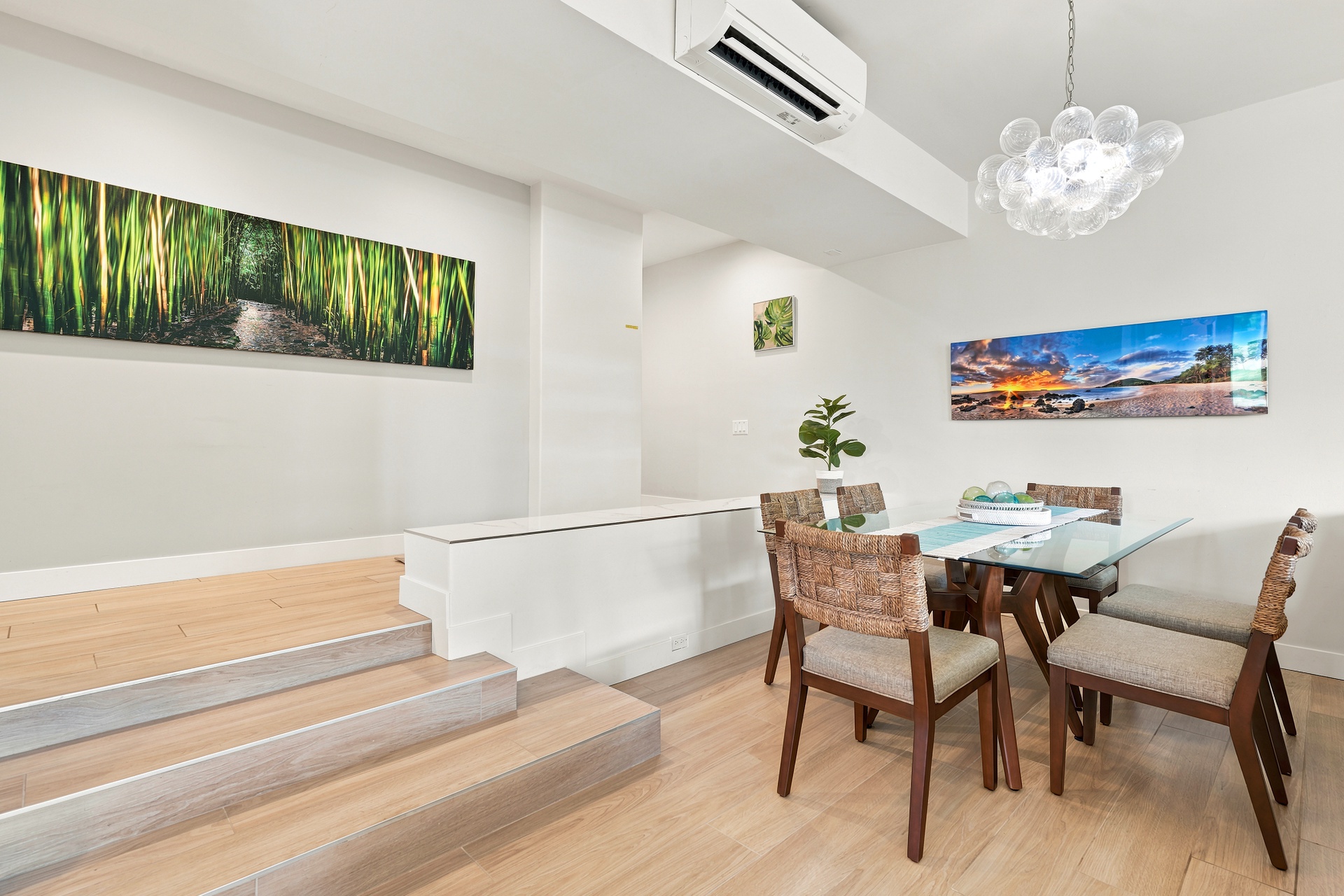 Gather around your dining table under a sculptural chandelier, where modern comfort meets warm natural touches. Climate-controlled air conditioning ensures your mealtime comfort.