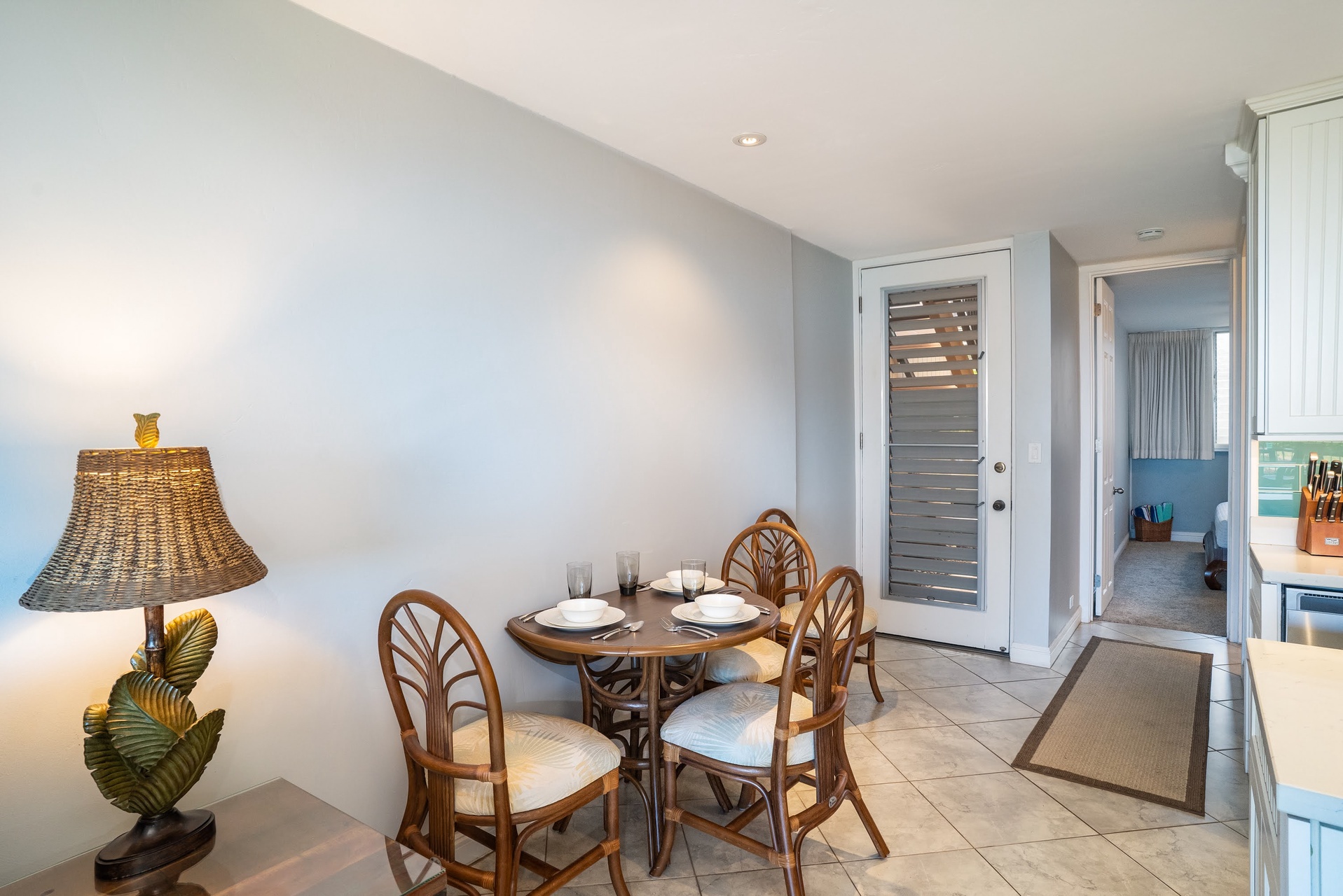 A bright dining nook with tropical décor awaits your morning coffee and evening meals, just steps from your private entrance and open-plan kitchen.