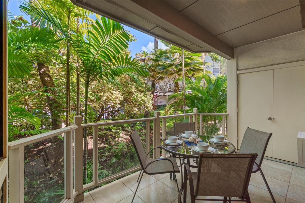 Relax on the lanai with serene garden and pool views