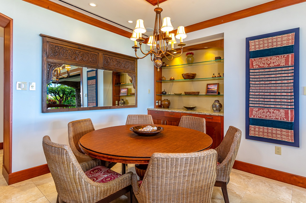 Gather around the elegant dining table where warm wood tones and soft lighting create the perfect setting for memorable meals together during your island escape.