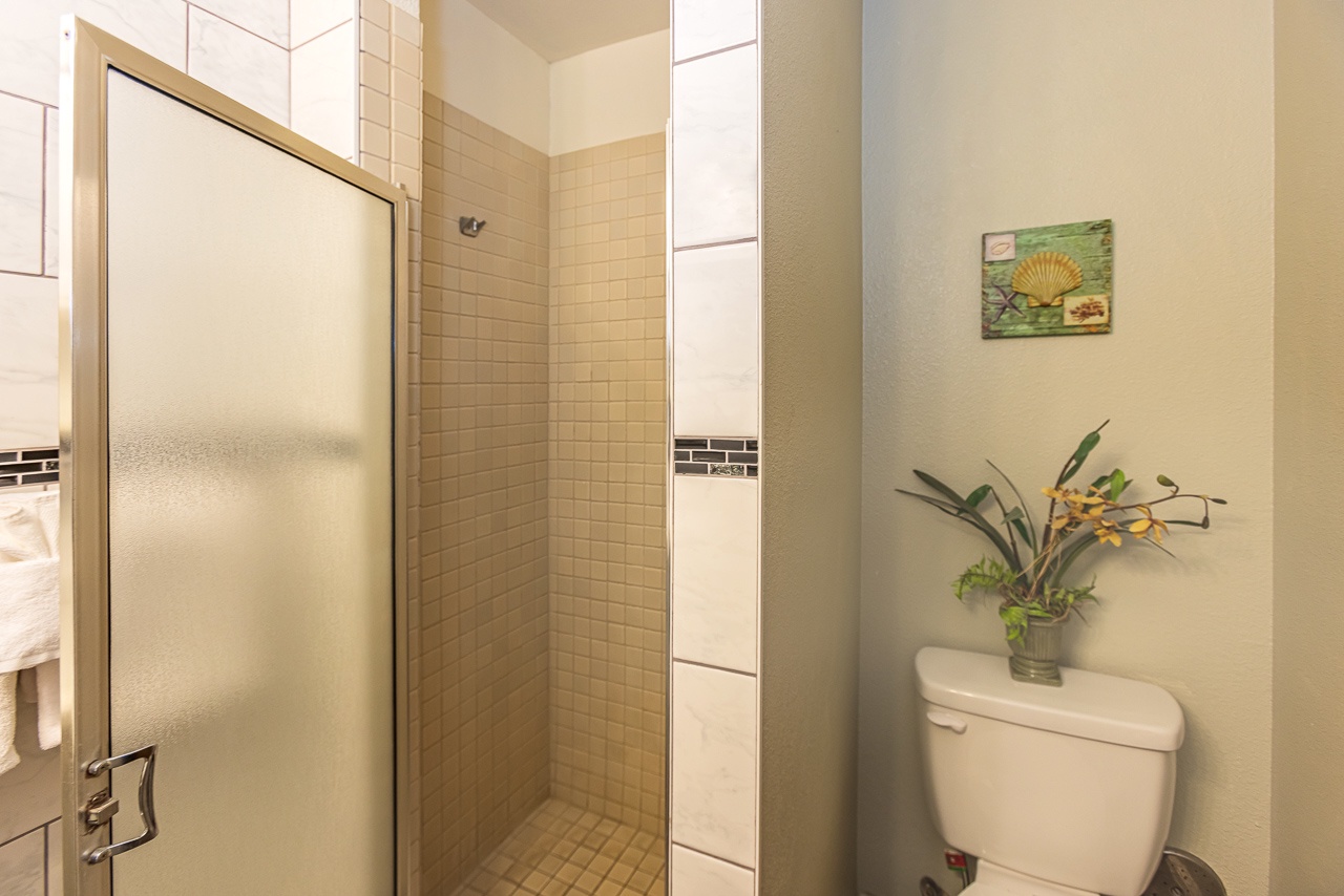 Private bathroom featuring a spacious tiled shower and thoughtful touches that make this feel like home.