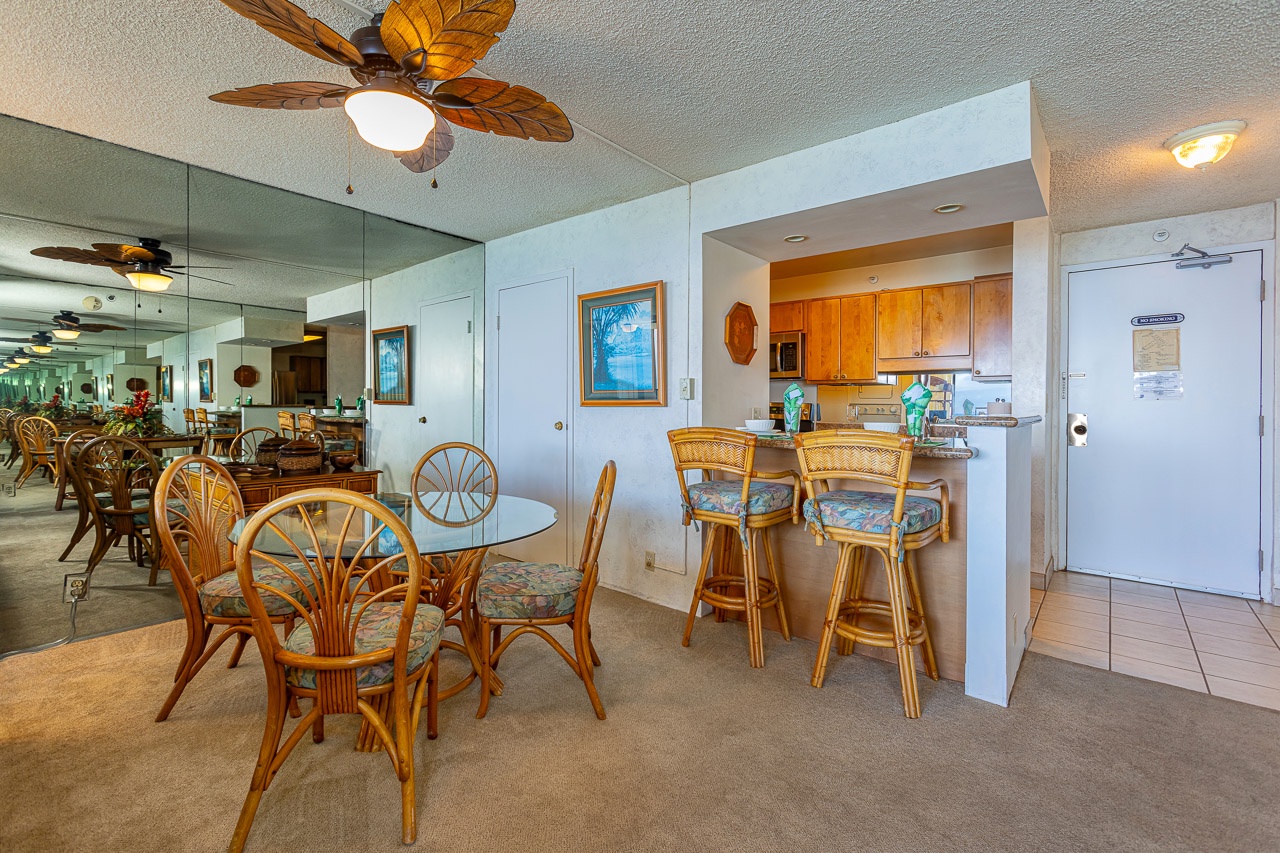 Gather around the tropical-themed dining table or relax at the breakfast bar in your open-plan living space, complete with charming rattan furnishings and coastal décor.
