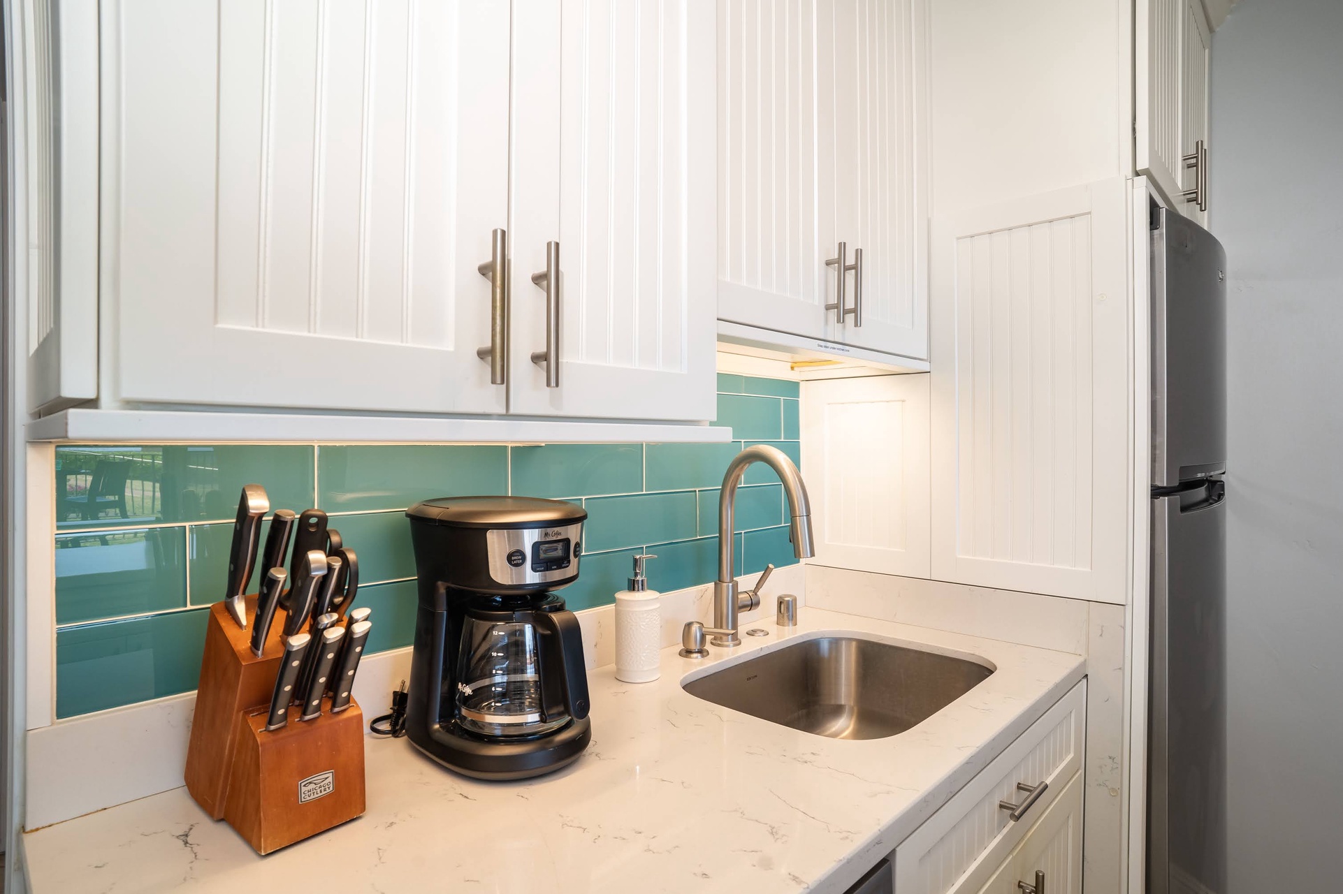 The kitchen includes a refrigerator, dishwasher, stovetop, oven, microwave, and coffee maker, for your convenience.