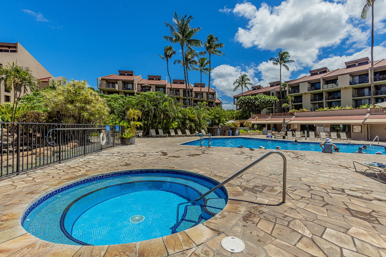 Soak in the hot tub or take a refreshing dip in the pool, surrounded by swaying palm trees and tropical greenery under bright Hawaiian skies.
