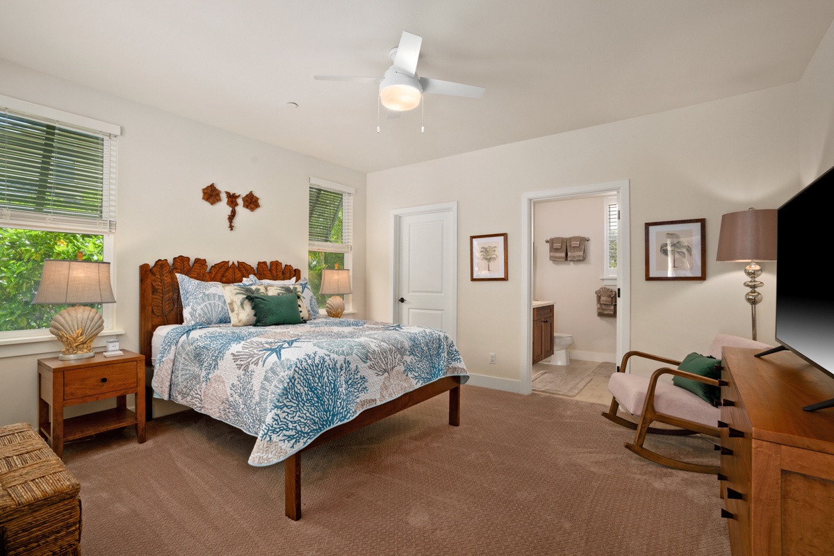 Your coastal retreat features a queen bed with ocean-inspired linens, gentle ceiling fan breezes, and warm wood furnishings that create your perfect sanctuary.