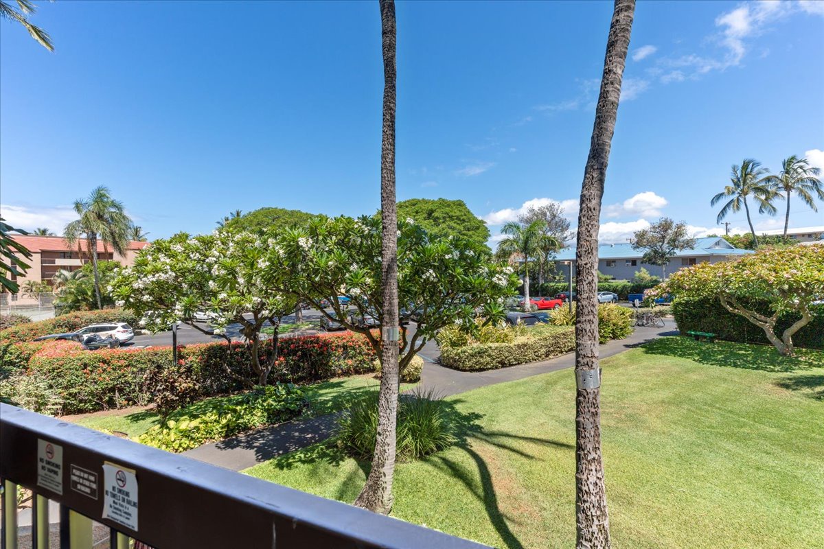 The property offers beautifully landscaped grounds with swaying palms, manicured lawns, and tropical greenery, creating a peaceful arrival experience.