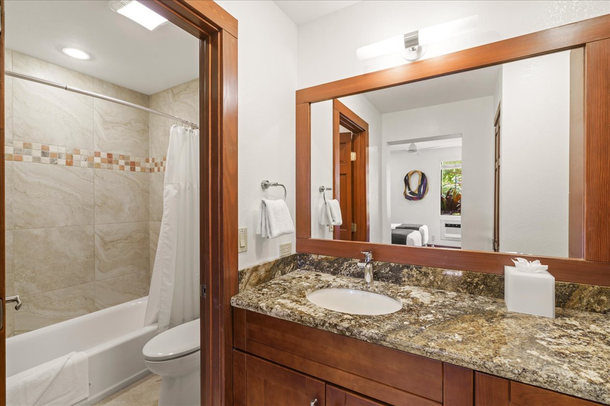Bright guest bathroom with both shower and tub for added comfort