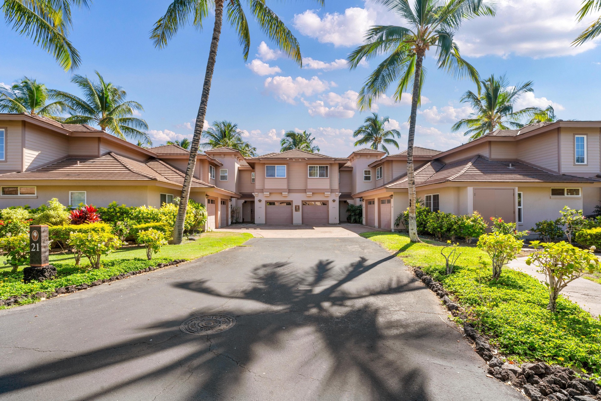 Multi-level vacation homes surrounded by swaying palms and tropical landscaping create an inviting resort-style atmosphere.