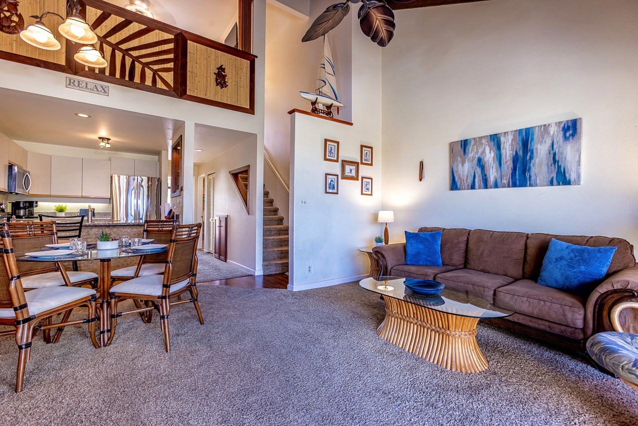 Spacious retreat with soaring ceilings and warm wood accents. Open-concept design flows from living to kitchen and dining areas, perfect for gathering.