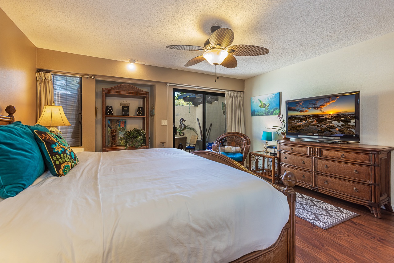 Unwind in your elegant bedroom featuring tropical charm, ceiling fan comfort, and thoughtful touches for a perfect night's rest.