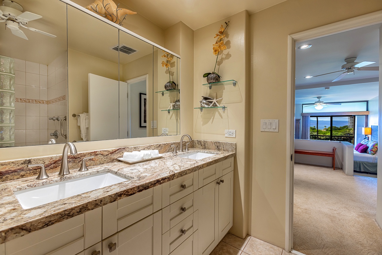 Your ensuite bathroom connects seamlessly to the bedroom, where ocean views invite you to unwind. Dual vanities and elegant granite counters set the tone for a relaxing stay.
