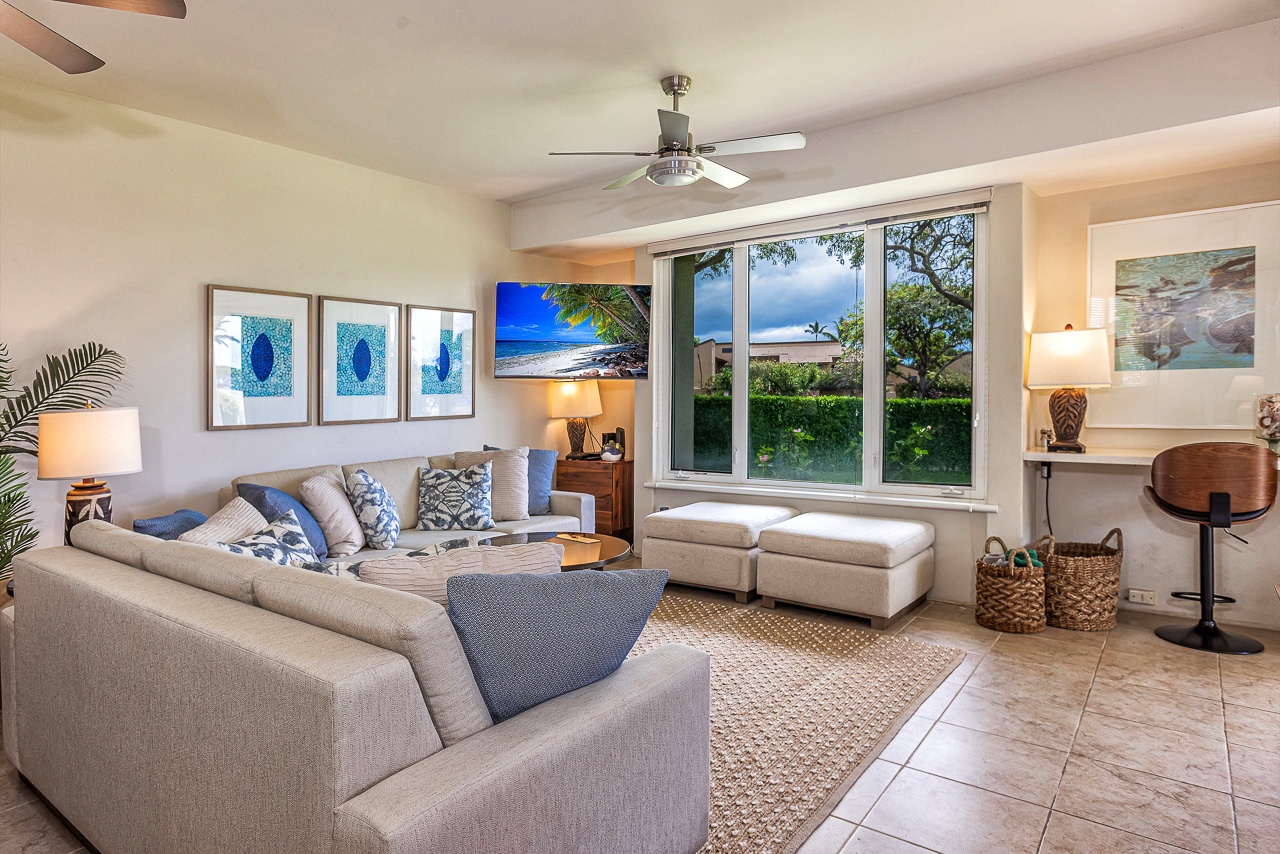 Sink into plush seating and let the tropical breezes drift in as you unwind—your perfect island retreat awaits with calming coastal décor and a serene garden view.