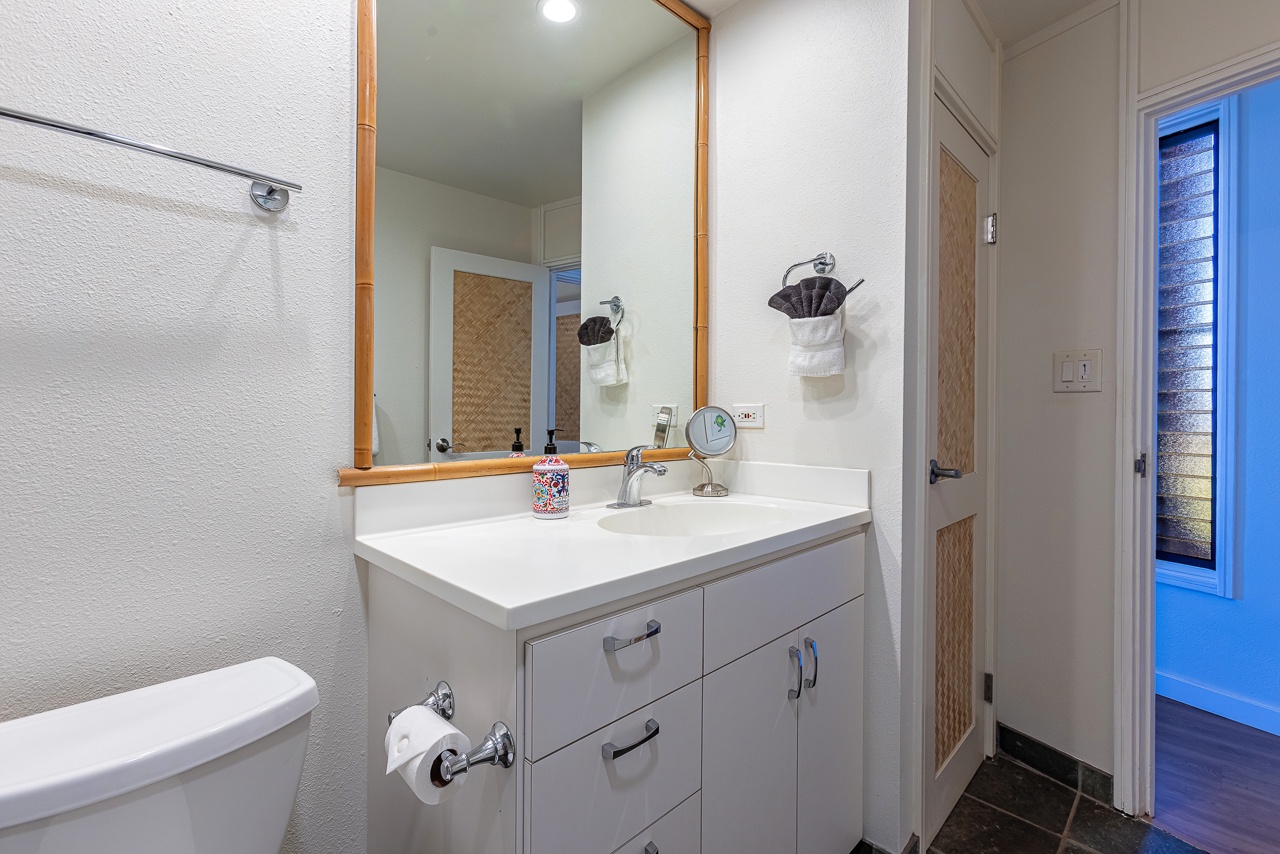 Your bright bathroom features a spacious vanity and thoughtfully arranged towels, creating a crisp and welcoming space where you can comfortably freshen up each morning.