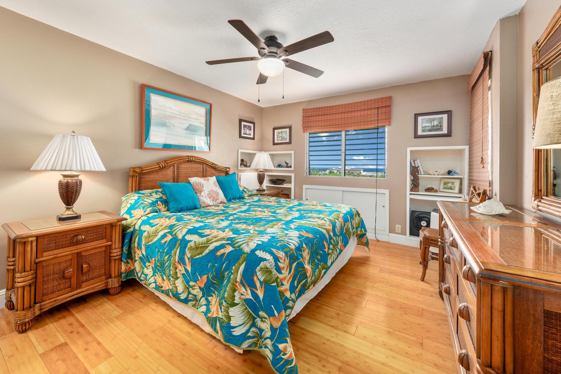 Your tropical bedroom sanctuary features rich wood furnishings, ceiling fan comfort, and vibrant island-style bedding for the perfect night's rest.