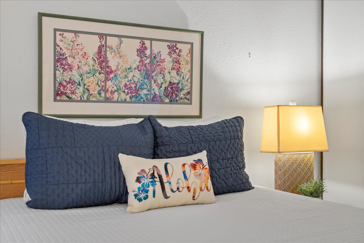 Drift off to the sounds of paradise in this inviting bedroom, offering a comfortable space to relax and recharge during your Maui escape.