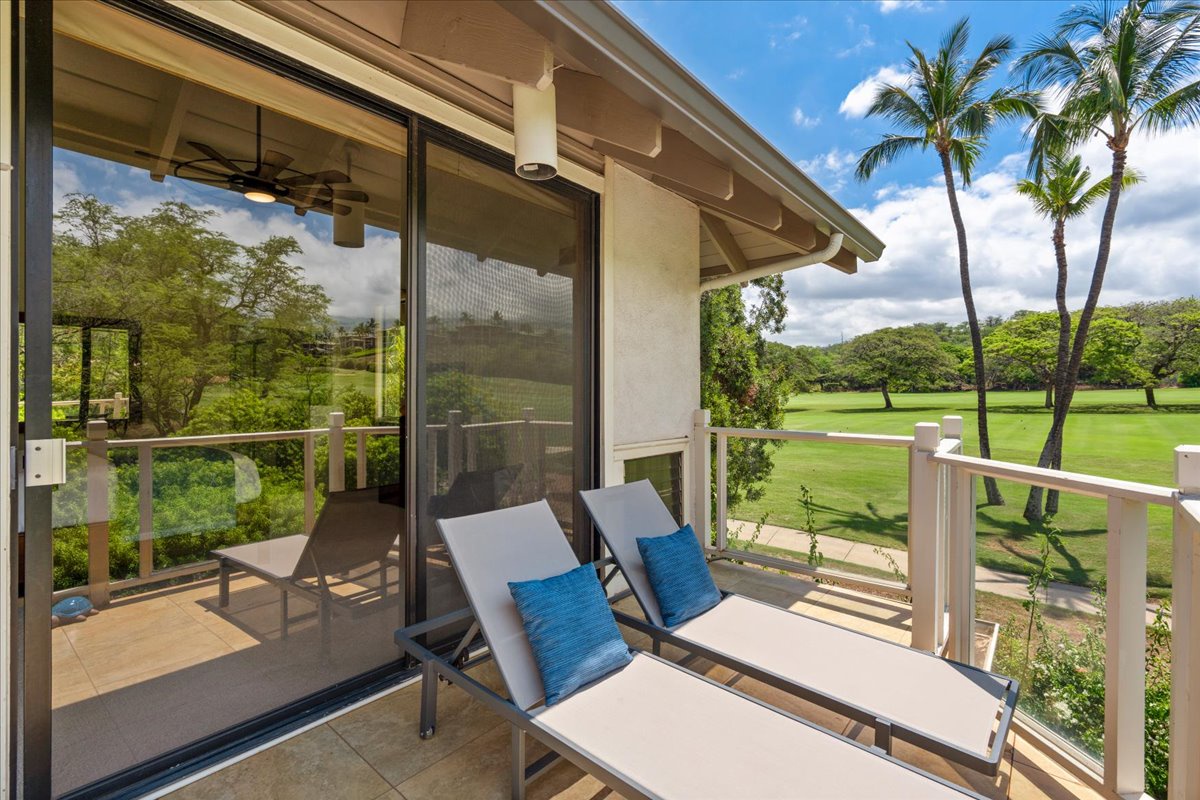 Unwind on your private balcony with cushioned loungers, tropical palm trees, and serene views of the lush golf course stretching beyond your retreat.