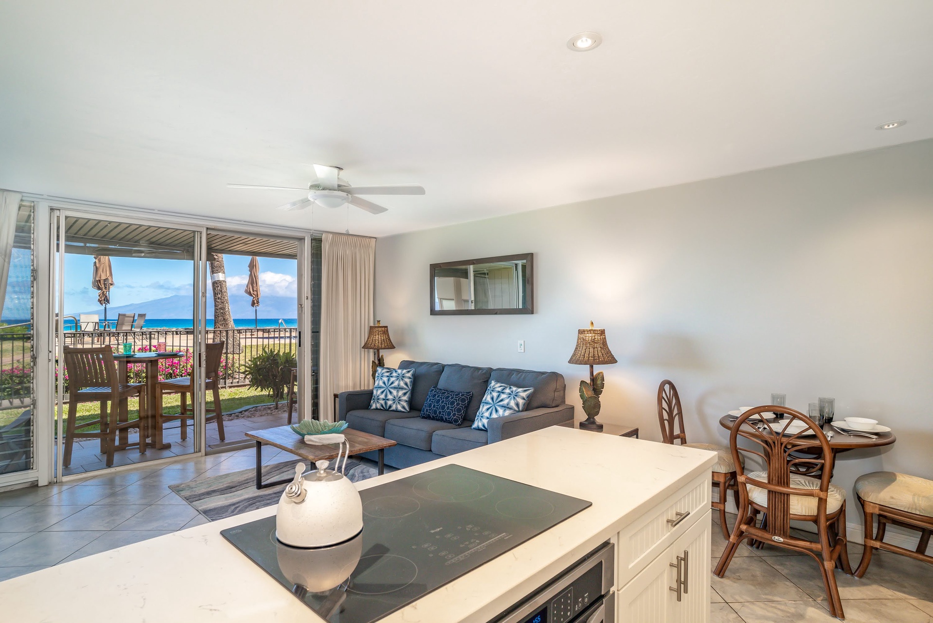 Picture yourself unwinding in this bright, open-concept living space with direct pool access from your private patio.