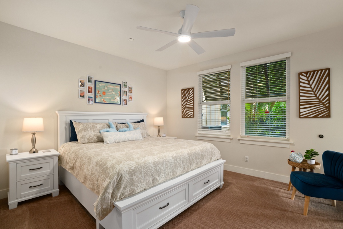 Drift into peaceful sleep in your bright bedroom with ceiling fan, storage bed, and leafy garden views through double windows.