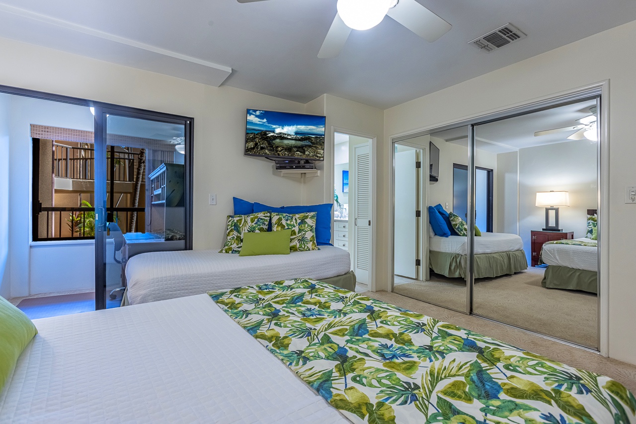 Step into your peaceful retreat with crisp linens, tropical accents, and sliding doors that invite soft natural light. Mirrored closets add depth while you enjoy the gentle breeze from your ceiling fan overhead.