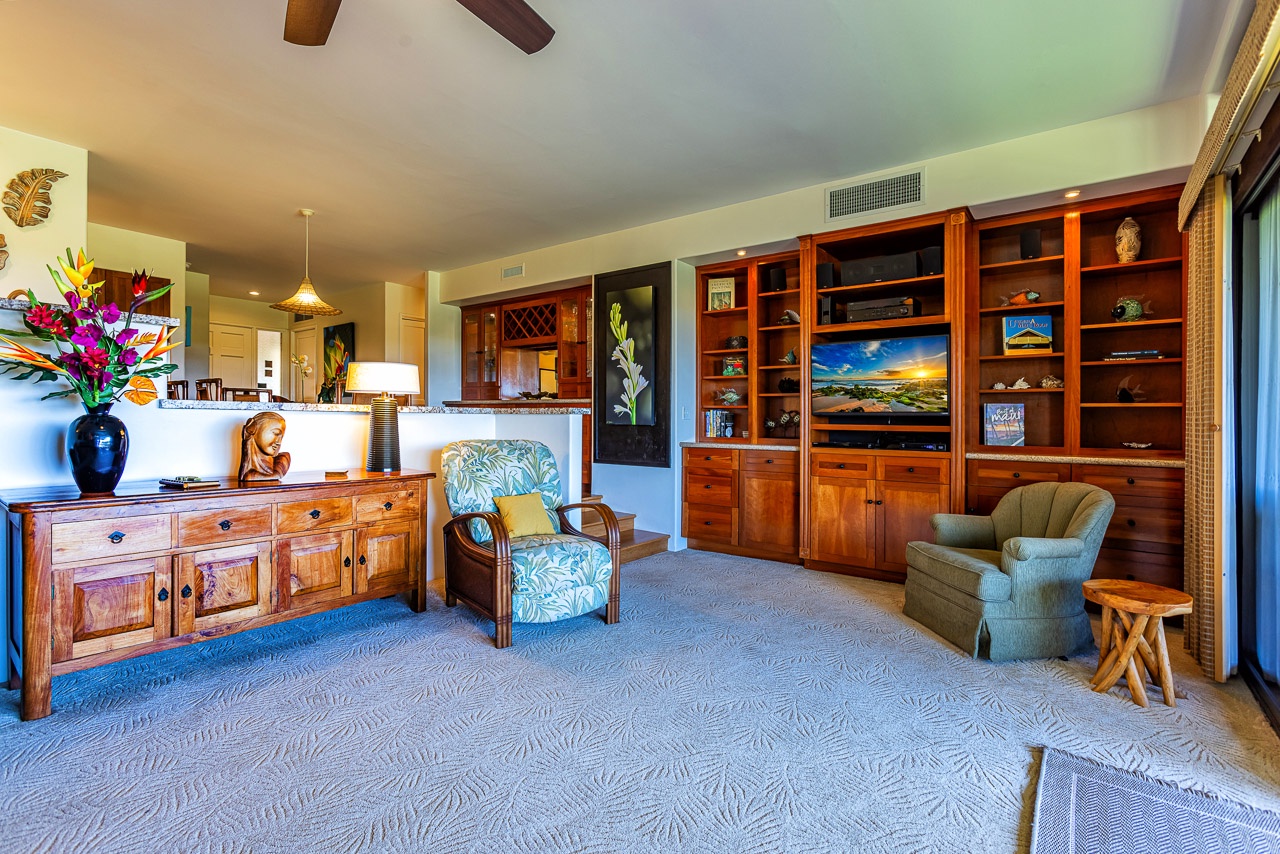 Relax in your spacious living area, where warm wood tones meet tropical flair.