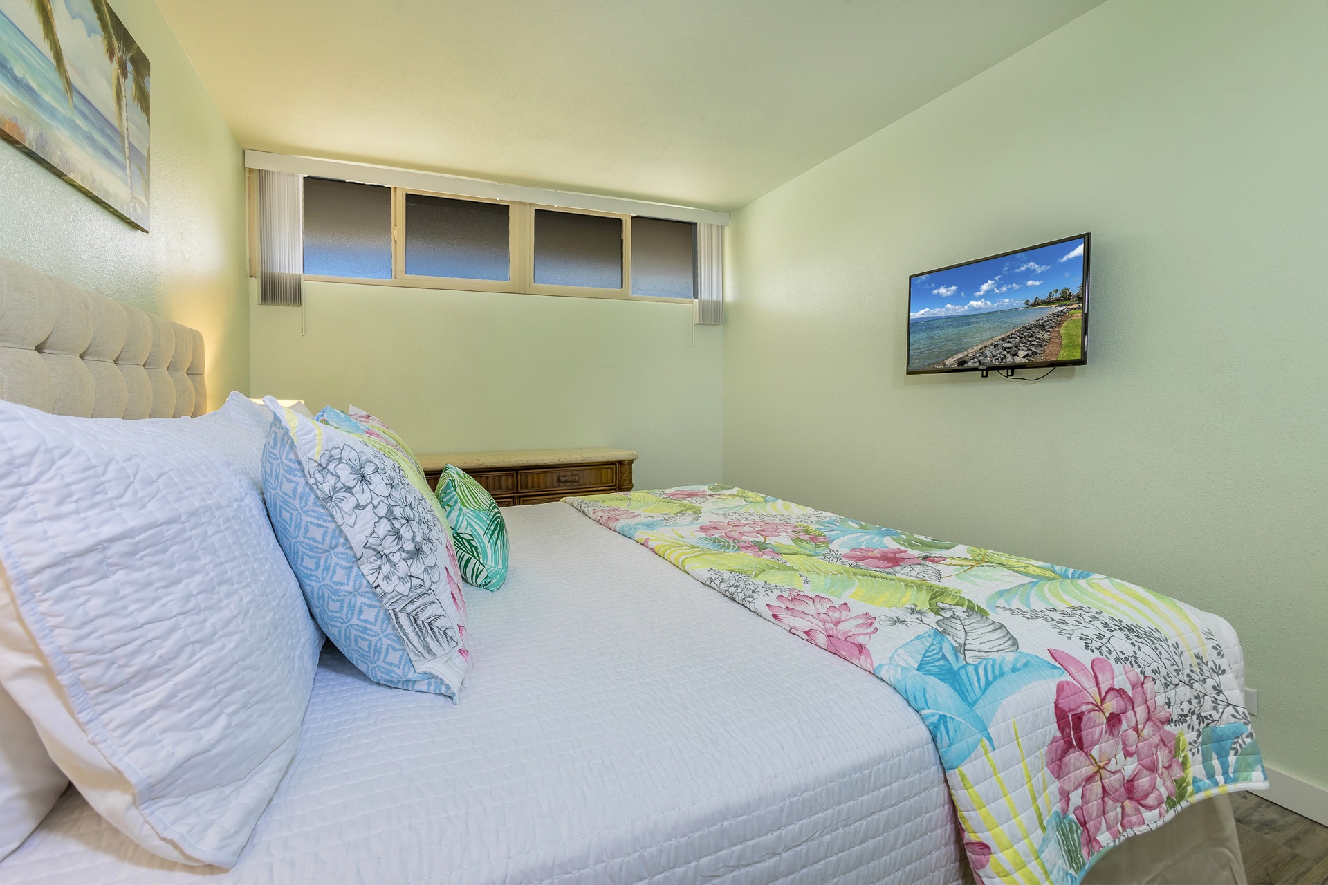Unwind in your bright, cheerful bedroom with soft linens and tropical accents that invite restful island dreams.