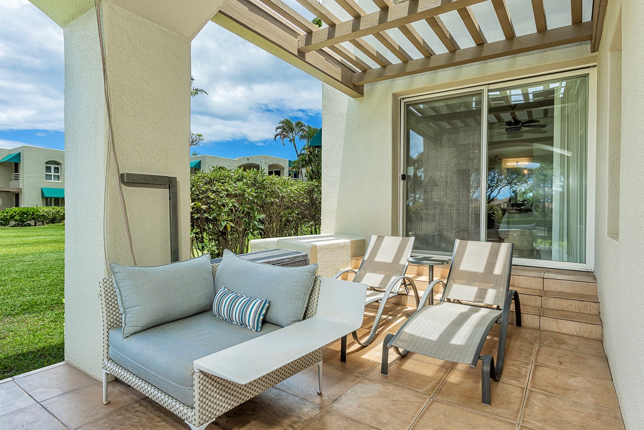 Your private covered patio offers a peaceful retreat with comfortable seating and lounge chairs, perfect for relaxing outdoors while enjoying views of the lush tropical surroundings.
