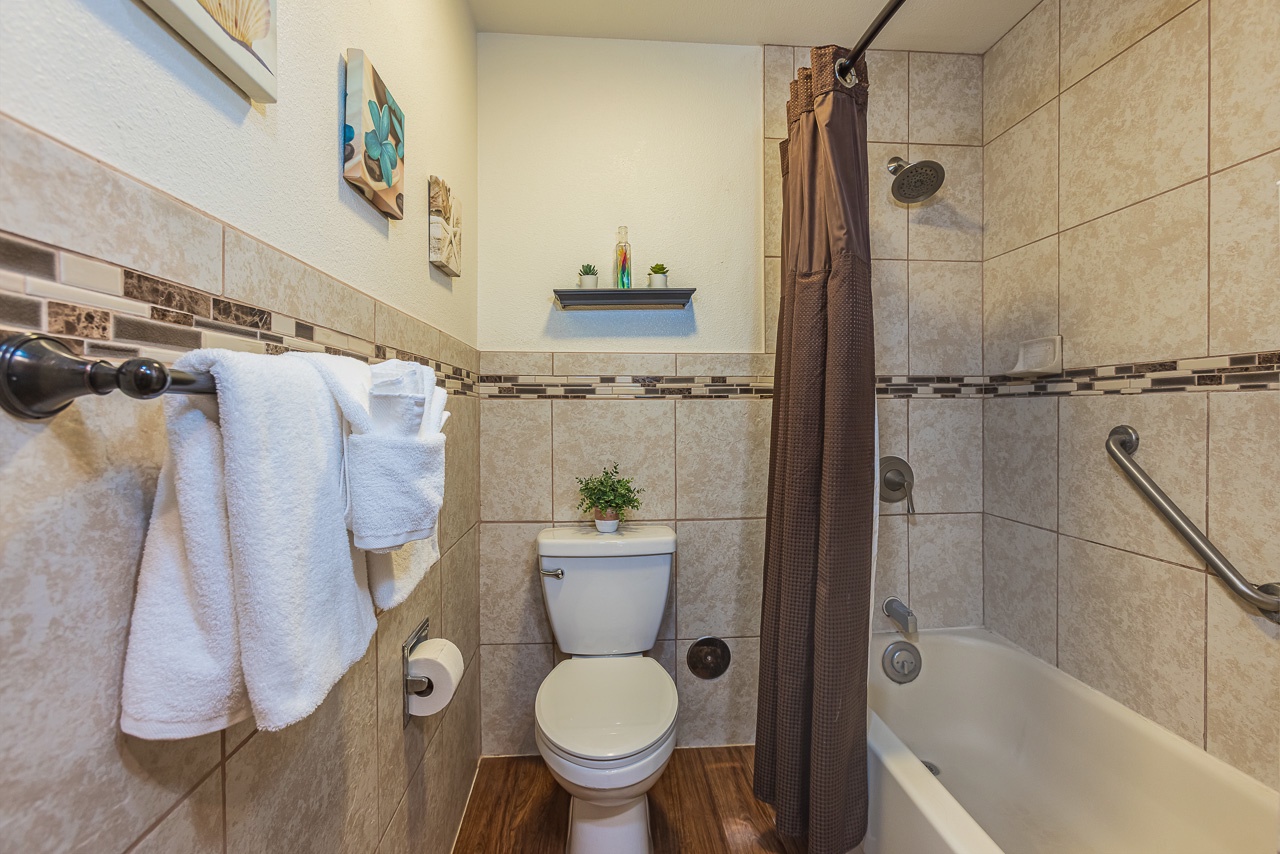 Your private bathroom features elegant tile work, fresh towels, and a relaxing tub-shower combo for unwinding after adventures.
