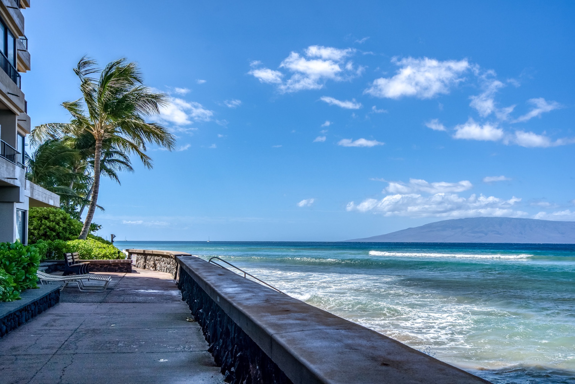 The property offers direct beachfront access, with the sparkling ocean and distant mountain views creating a stunning tropical backdrop for your island getaway.