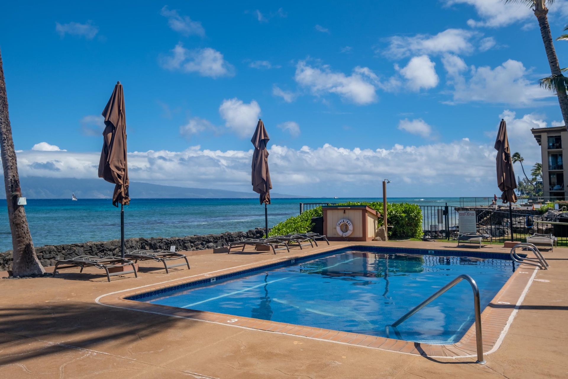 The deck offers lounge chairs beneath retractable umbrellas, creating your private escape.