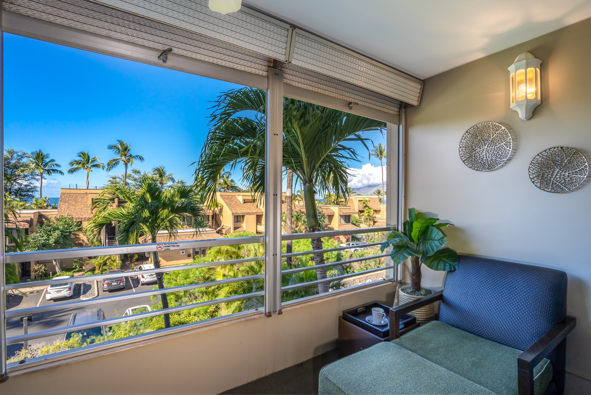 Relax in your private balcony oasis, where tropical palms frame endless blue skies and gentle breezes invite you to unwind with morning coffee or evening reflections.