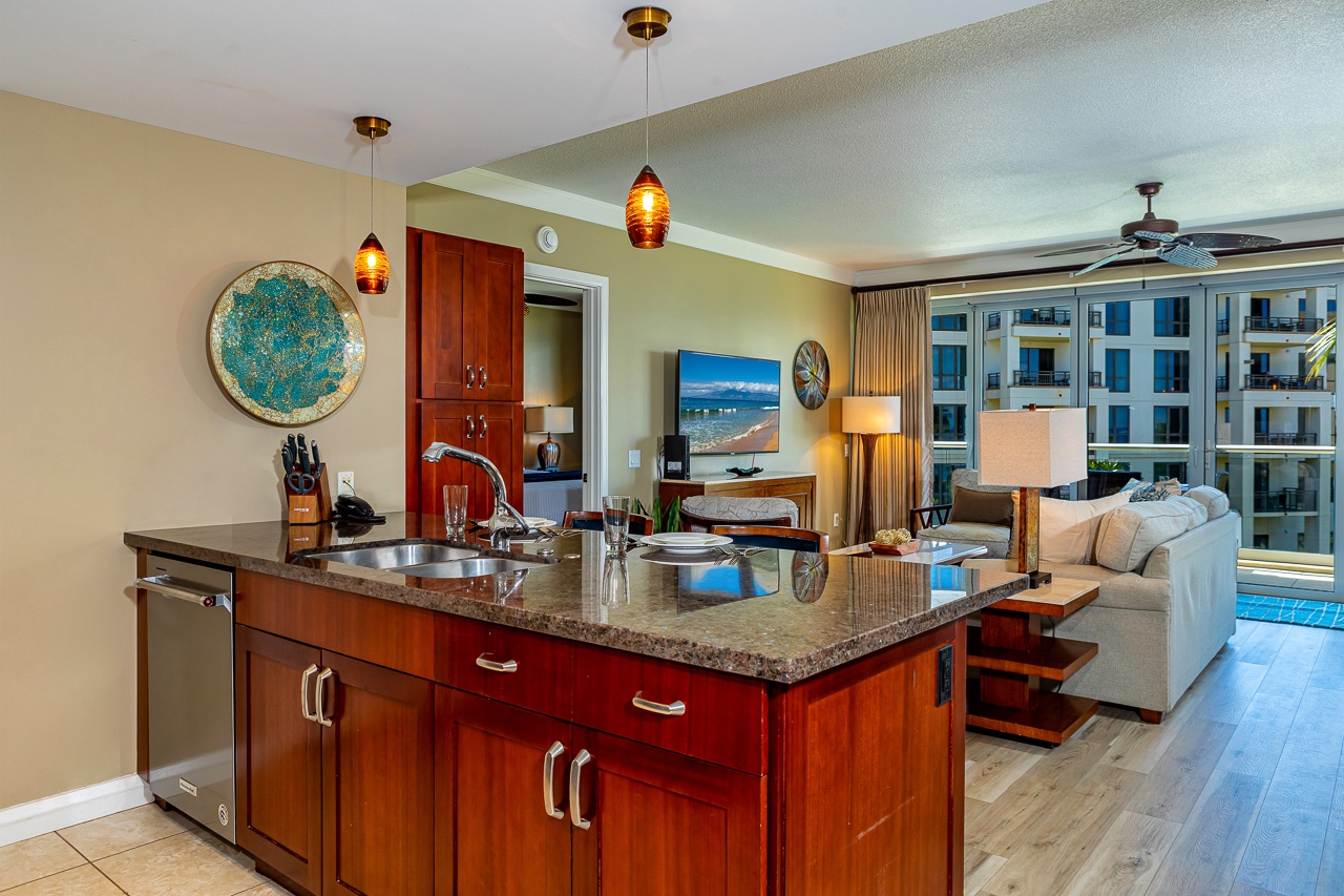 Your open-concept kitchen and living space offers everything you need for relaxed island living, from granite counters and rich wood cabinetry to warm lighting and serene views.