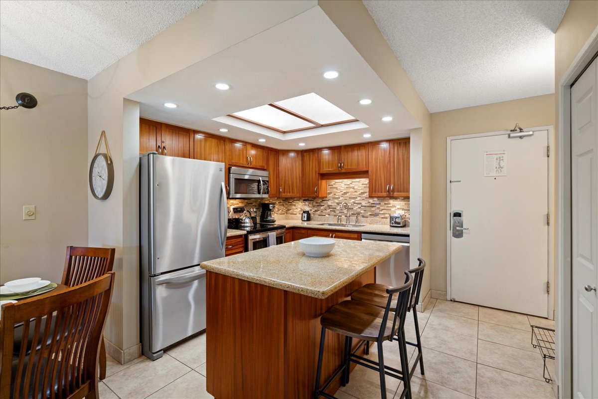 Bright, open kitchen with breakfast bar seating for two