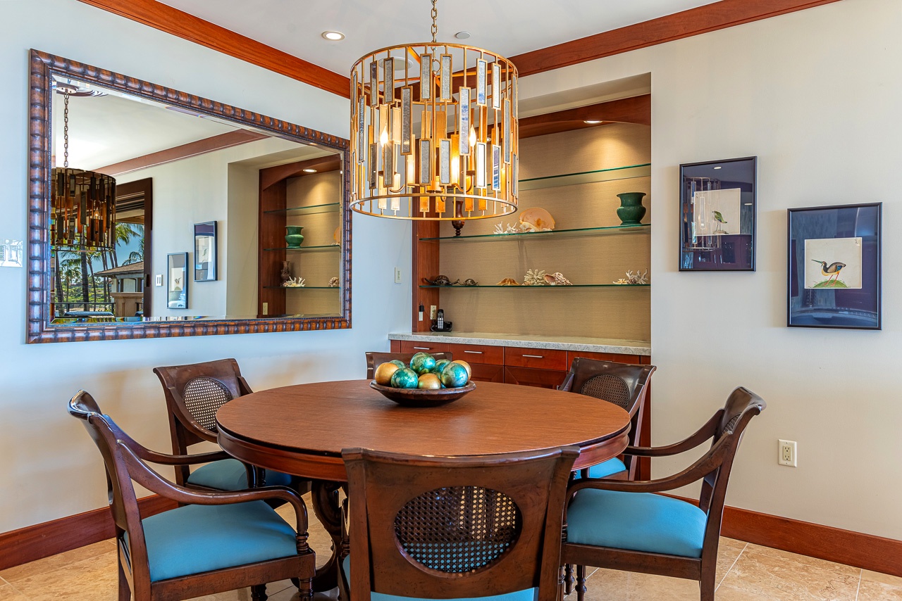 Gather around an elegant dining table where rich wood tones and a striking chandelier create the perfect setting for your shared meals and memorable conversations.